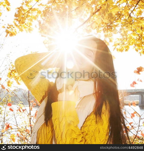 Happy woman in autumn park. Happy woman posing in sunny autumn park