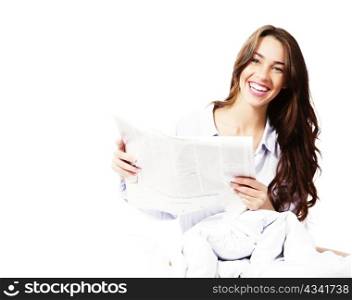 happy woman in bed with a newspaper. happy woman in bed with a newspaper on white background