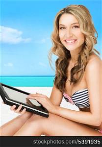happy woman in bikini with tablet pc computer on the beach