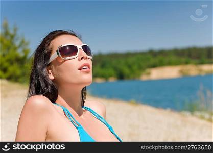 Happy woman in blue bikini bra on beach sunny day
