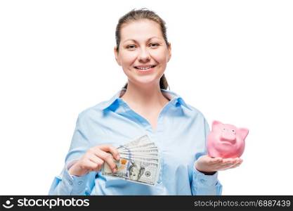 Happy woman in blue shirt with dollars and piggy bank on white background