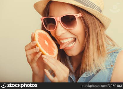 Happy woman in hat drinking grapefruit juice. Diet. Happy glad woman tourist in straw hat drinking grapefruit juice. Healthy diet food. Weight loss. Summer vacation holidays. Instagram filtered.