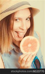 Happy woman in hat drinking grapefruit juice. Diet. Happy glad woman tourist in straw hat drinking grapefruit juice. Healthy diet food. Weight loss. Summer vacation holidays. Instagram filtered.