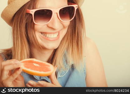 Happy woman in hat drinking grapefruit juice. Diet. Happy glad woman tourist in straw hat drinking grapefruit juice. Healthy diet food. Weight loss. Summer vacation holidays. Instagram filtered.