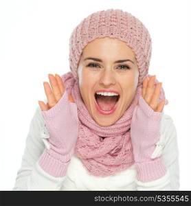 Happy woman in knit winter clothes shouting through megaphone shaped hands