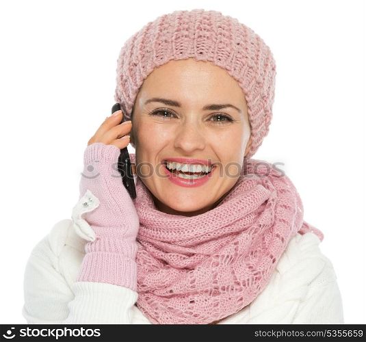 Happy woman in knit winter clothing making phone call