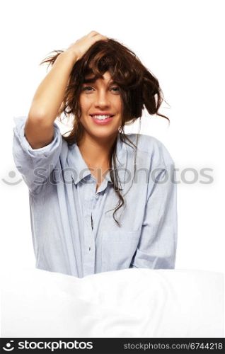 happy woman in pajamas playing with her hair. happy woman in pajamas playing with her hair on white background