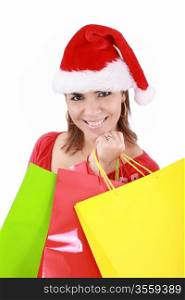 Happy woman in Santa hat holding shopping bags, over a white background.