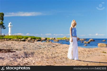 happy woman in striped vest on the seashore