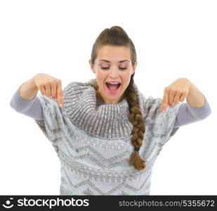 Happy woman in sweater pointing down