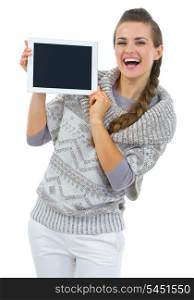 Happy woman in sweater showing tablet PC blank screen