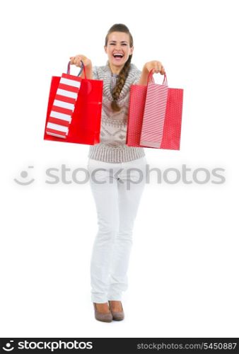 Happy woman in sweater with red shopping bags