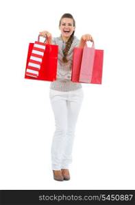 Happy woman in sweater with red shopping bags