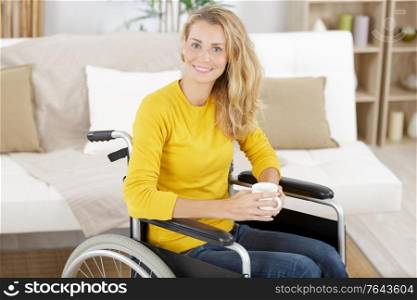 happy woman in wheelchair having tea