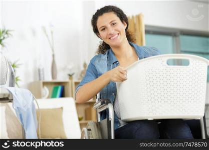happy woman in wheelchair holding basket