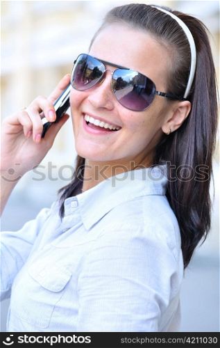 happy woman is looking back and talking phone