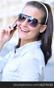 happy woman is looking back and talking phone