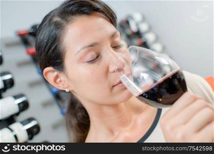happy woman is smelling red wine