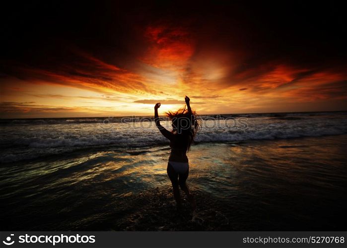 Happy Woman Jumping in Sea Sunset. Happy Woman in bikini Jumping in Sea Sunset
