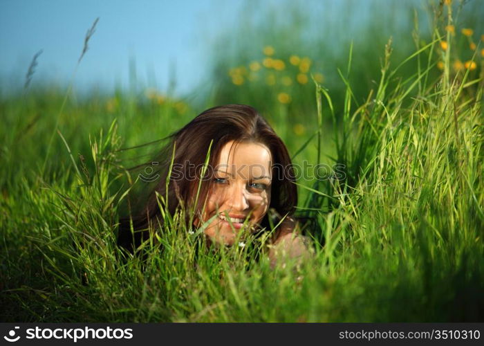 happy woman lay on green grass