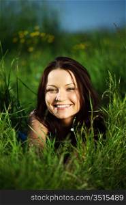 happy woman lay on green grass