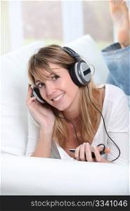 Happy woman listening to music at home