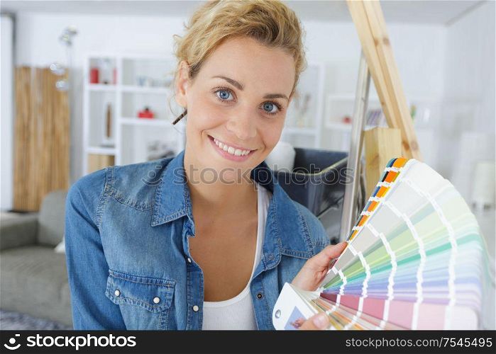 happy woman looking to a color palette