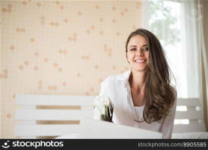 Happy woman lying on the bed with tablet computer