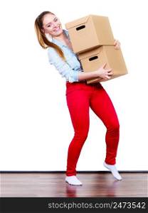 Happy woman moving in carrying cartons boxes. Young girl arranging interior and unpacking at new apartment house home.. Happy woman moving into house carrying boxes.