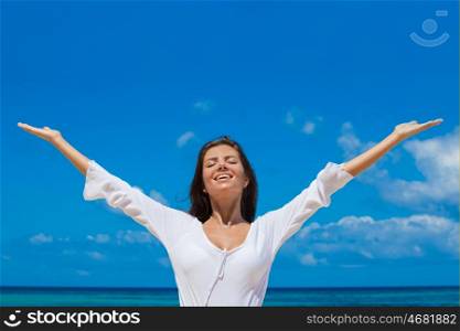 Happy woman on beach. Happy smiling woman enjoy vacation on beach with raised hands