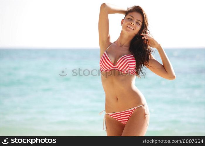 Happy woman on beach. Happy woman in bikini posing on beach in Thailand