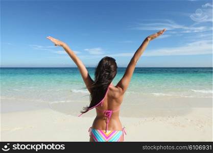 Happy woman on beach. Happy woman with raised hands on beach