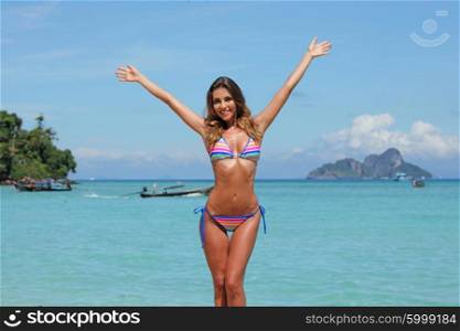 Happy woman on beach. Happy woman with raised hands on beach in Thailand