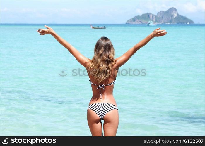 Happy woman on beach. Happy woman with raised hands on beach in Thailand