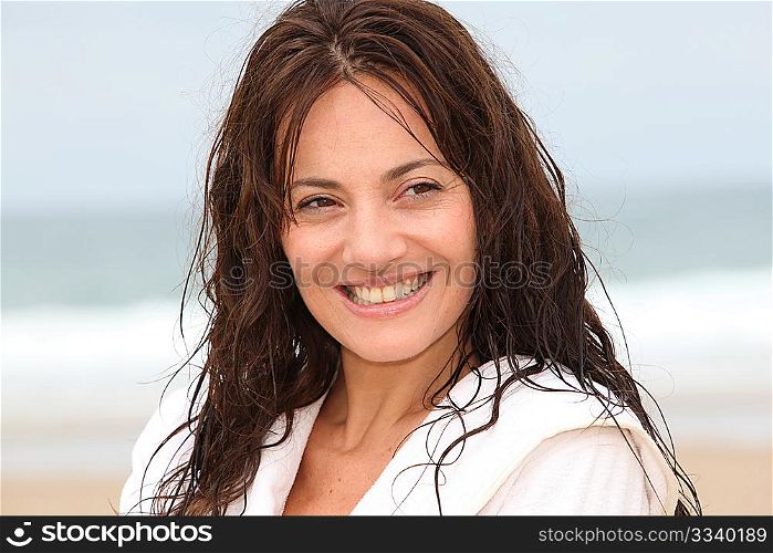 Happy woman on the beach during spa treatment
