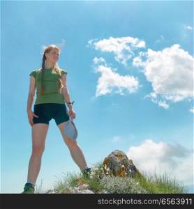 Happy woman on the top of a mountain. Happy woman on the top of a mountain with blue sky and clouds