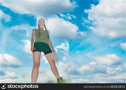 Happy woman on the top of a mountain. Happy woman on the top of a mountain with blue sky and clouds