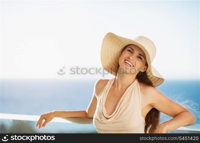 Happy woman on vacation standing on balcony