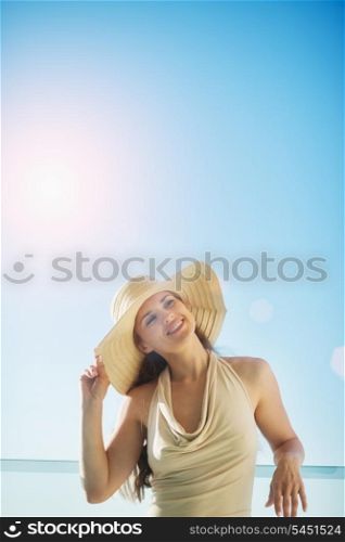 Happy woman on vacation standing on balcony