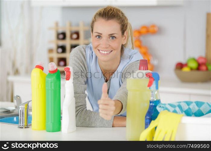 happy woman or housewife showing thumbs up