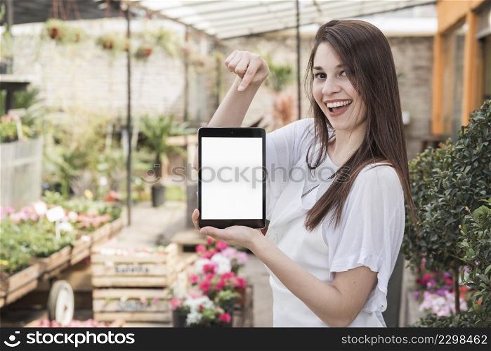 happy woman pointing digital tablet with blank white screen