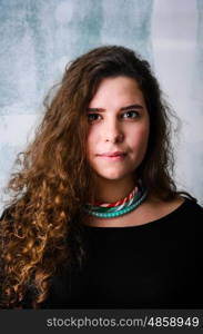 Happy woman portrait. Portrait of young adult happy woman against grunge wall