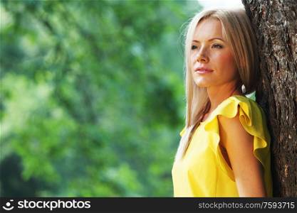 happy woman posing against a background of trees. happy woman in forest
