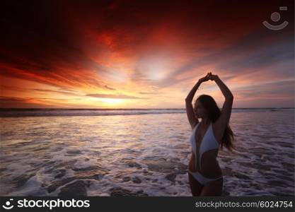 Happy woman posing on the beach at sunset, Bali, Seminyak, Double six beach