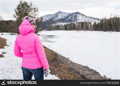 Happy woman relaxing on the coast river at beauty sunny winter day, in Altai mountains. Travel vacation concept.. Happy woman relaxing on the top of mountain