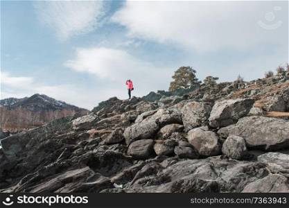 Happy woman relaxing on the top of mountain at beauty sunny spring day, in Altai mountains. Travel vacation concept.. Happy woman relaxing on the top of mountain