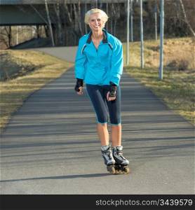 Happy woman roller skating sport smiling in park sunny day