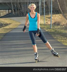 Happy woman roller skating sport smiling in park sunny day