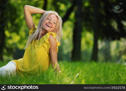 happy woman sitting on grass