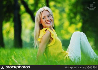 happy woman sitting on grass